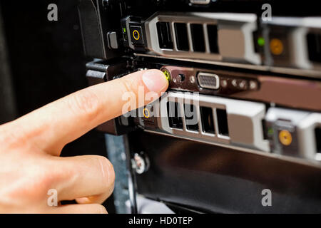 Engineer's Finger Switching On Server Stock Photo