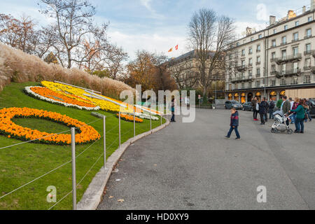 Geneva, Switzerland - November 20, 2016: Ordinary tourists take photos near famous flower clock, one of the popular tourist attractions of Geneva Stock Photo