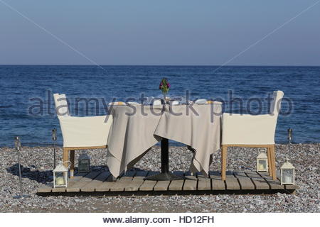 Romantic dinner table set for two in a private tent by the beach on ... Romantic dinner table set for two in a private tent by the beach on ...
