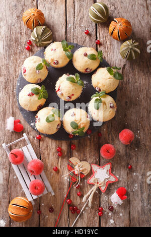 Freshly baked muffins with cranberries close-up on the table. vertical view from above Stock Photo