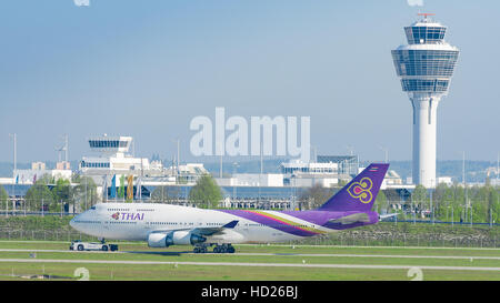 Jet airliner Boeing 747 of Thai Airways International airlines taxiing on pushback tug at Munich international passenger airport Stock Photo