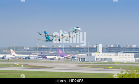 Plane Embraer E-Jet ERJ-195 of Air Dolomiti airlines taking off and gaining altitude from Munich international passenger airport Stock Photo