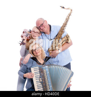 musical family with saxophone, violin and accordion hugs in studio against white background Stock Photo