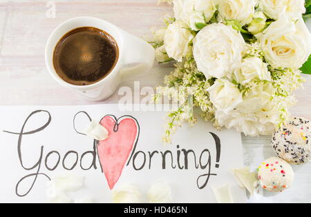 white roses, coffee and good morning note on a table Stock Photo