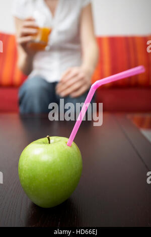 Straw in apple, pure apple juice Stock Photo