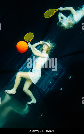 Woman playing tennis underwater Stock Photo - Alamy