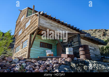 Disturbing angle of abandoned building at Techatticup Mine, a gold + silver mine and ghost town used as a movie set in Nevada. Stock Photo