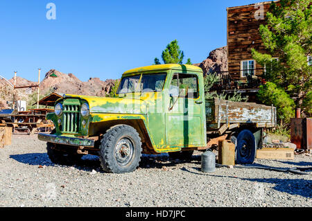 Old pickup truck with wooden truck bed and faded peelpaint in desert sun at Techatticup Mine near Route 66 often used as a filming location in Nevada. Stock Photo