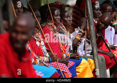 Amboseli, Kenya. 10th Dec, 2016. Maasai women watch the Maasai Olympics in Sidai Oleng Wildlife Sanctuary near Amboseli, Kenya, Dec. 10, 2016. The biennial Maasai Olympics, which was first launched in 2012 to give Maasai warriors an avenue to demonstrate their physical prowess through a sporting event rather than a traditional lion hunt, also aims to raise awareness about the many threats lions are facing. © Zhou Xiaoxiong/Xinhua/Alamy Live News Stock Photo