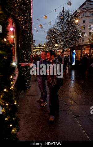 London, UK. 10th Dec, 2016. Christmas Shopping in Londons West End on 10/12/2016 at Oxford Street , . Shoppers stop to admire the Selfridges window displays. Credit:  Julie Edwards/Alamy Live News Stock Photo