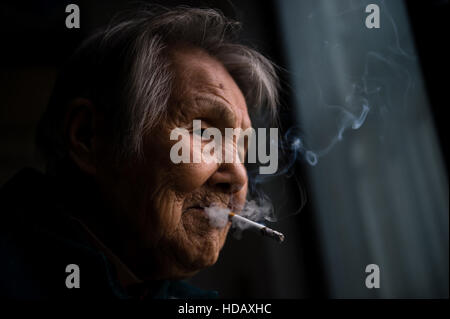 (161211) -- NANJING, Dec. 11, 2016 (Xinhua) -- Ma Xiuying smokes Nov. 18, 2016. Ma Xiuying, born in 1922, survived by escaping to a refugee zone with her mother during the invasion of Japanese troops in 1937.   Japanese troops occupied eastern China's Nanjing on Dec. 13, 1937, and began a six-week massacre. Chinese records show more than 300,000 people -- not only disarmed soldiers but also civilians -- were brutally murdered and thousands of women raped. In the past 79 years, the number of survivors decreases. After Zhang Fuzhi, 89, passed away on Nov. 26, 2016, the number of the registered s Stock Photo