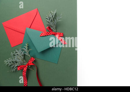 Red and green envelopes on christmas holiday background. Flat lay. Stock Photo
