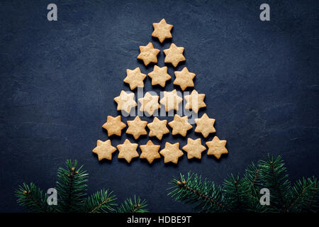 Christmas or New Year tree made of stars shaped cookies. Abstract image with copy space. Holiday, Christmas, New Year concept. Stock Photo