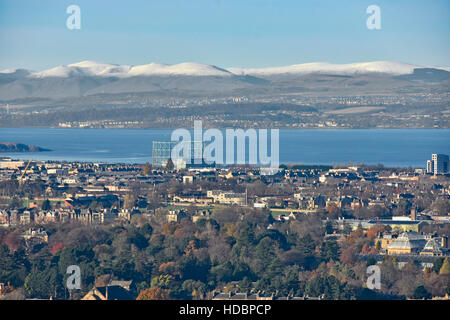 Looking down from top of Carlton Hill over Edinburgh urban sprawl winter Scottish landscape scene Firth Of Forth & rural snow covered hill tops beyond Stock Photo