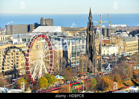 Scotland uk Edinburgh European Christmas Market & Ferris fairground ride East Princes Street gardens Scott Monument Scottish Firth of Forth distant Stock Photo