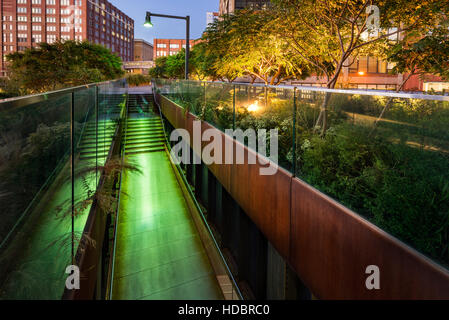 The High Line promenade illuminated at twilight in the West Village. The aerial greenway is also known as Highline or High Line Park. It is a former e