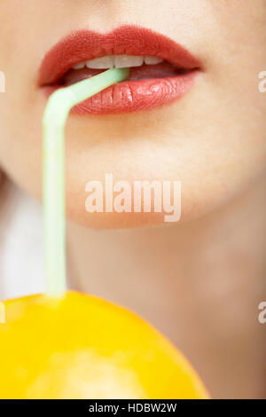 Woman drinking pure orange juice Stock Photo
