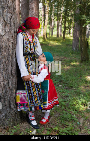 Young mother posing with her little girl in traditional Bulgarian costume Stock Photo