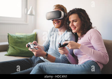 Couple having fun playing with virtual reality Stock Photo