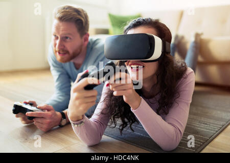 Couple having fun playing with virtual reality Stock Photo