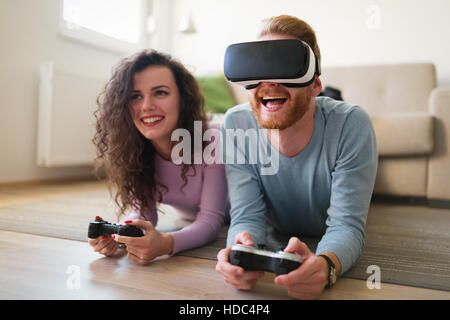 Couple having fun enjoying VR and playing games Stock Photo