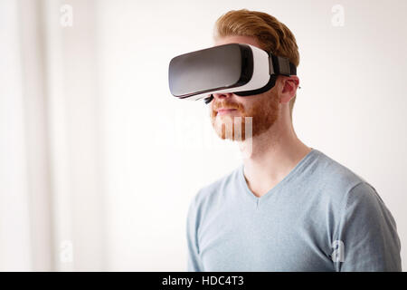 Handsome man wearing future technology VR glasses Stock Photo