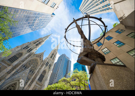 NEW YORK CITY - SEPTEMBER 3, 2016: The statue of Atlas in Rockefeller Center stands across from St Patrick's Cathedral. Stock Photo