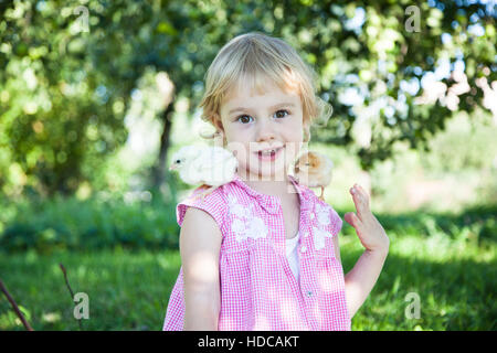 Cute girl with little chicks Stock Photo