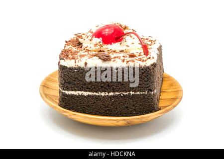 Chocolate cake garnished with cherry and white cream on white background Stock Photo