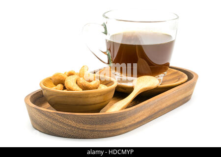 Salty cashew nuts and a cup of black coffee in a tray on white background Stock Photo