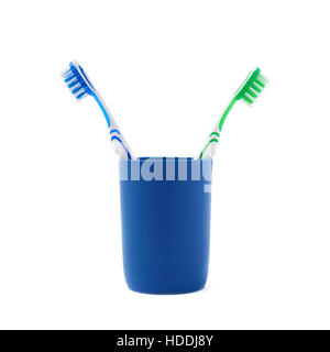 Pair of toothbrushes in blue plastic cup isolated over white background Stock Photo