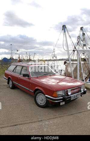 Ford Granada estate car on quayside with fishing boats behind Stock Photo