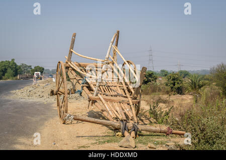 A bullock cart is standing on the roadside. Stock Photo