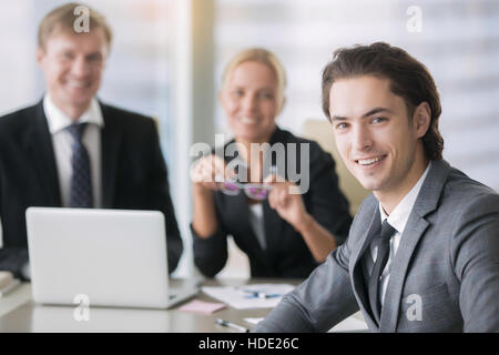 Group of business people and a smiling young man