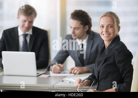 Group of businessmen at the modern office desk Stock Photo