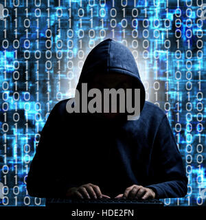 anonymous hacker in hood typing on a keyboard, with binary background Stock Photo
