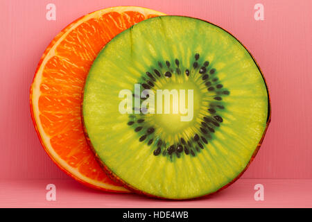 Decorative pillows designed as Kiwi and Orange on pink background Stock Photo
