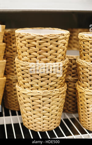 woven straw baskets on a shelf in store Stock Photo