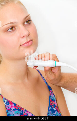 Young woman getting ultrasound of a thyroid from doctor Stock Photo