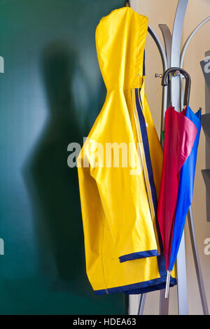 Raincoat and colorful umbrella Stock Photo