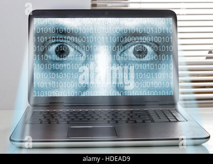 Face on a computer watching you Stock Photo