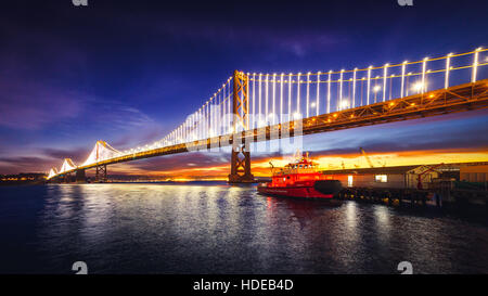 San Francisco Oakland Bay Bridge Illuminated at Sunrise, California Stock Photo