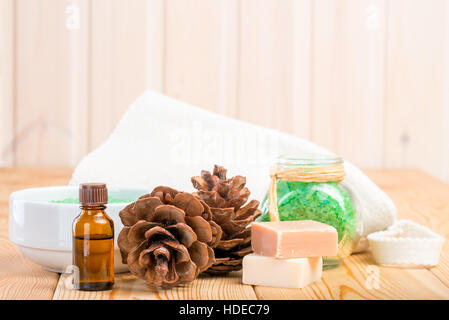 pine essential oil and bath salts close up on wooden boards Stock Photo