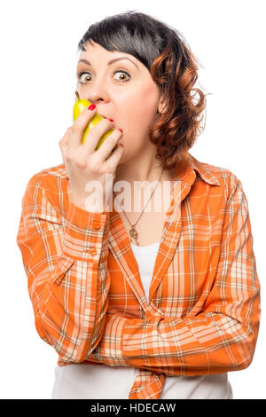 slender girl bites a ripe yellow pear on a white background Stock Photo