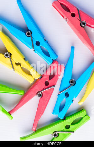 a bunch of colorful clothespins on a white background closeup Stock Photo
