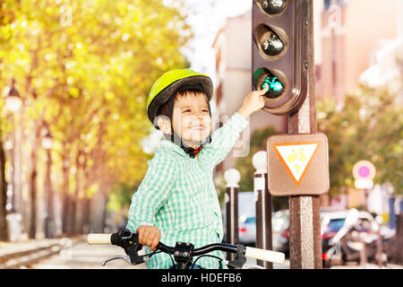 Boy cycling on his bike and learning traffic rules Stock Photo