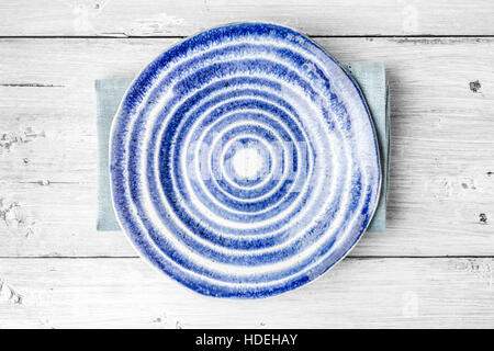 Blue and white ceramic plate on the white wooden table Stock Photo
