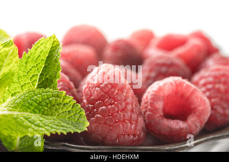 Raspberries with mint on the metal plate Stock Photo