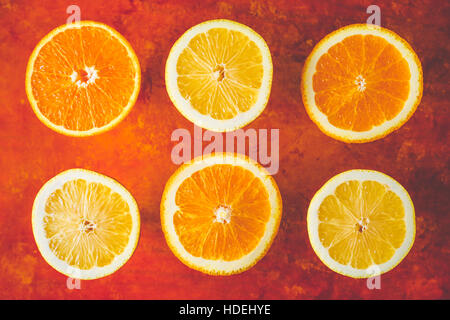 Lemon and orange slices on the terracotta background horizontal Stock Photo