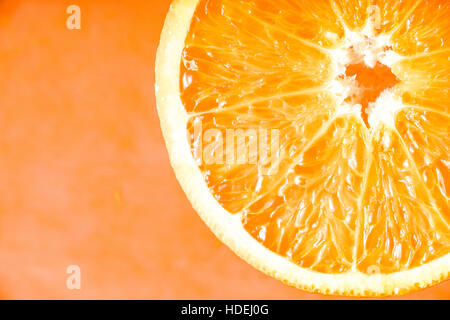 Orange slice on the terracotta background close-up Stock Photo